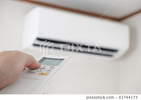 Image of turning on the air conditioner with a remote control Image of turning on the air conditioner with a remote control 81744173