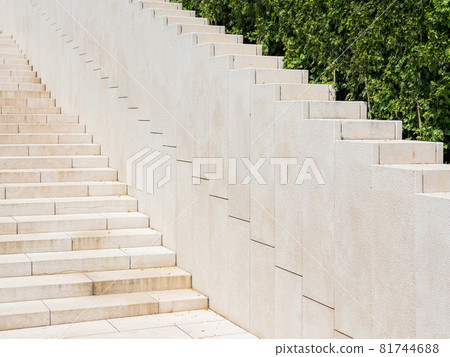 Ornamental garden with trimmed bushes and beige staircase. Geometrical background with shrubs and architectural construction. Diagonal perspective. Ornamental garden with trimmed bushes and beige staircase. Geometrical background with shrubs and architectural construction. Diagonal perspective. 81744688