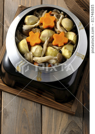 將栗子、胡蘿蔔、蘑菇和舞茸一起放入鍋中煮飯。 81746885