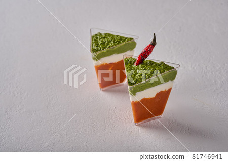 Verrine mousse from baked pepper with creamy gorgonzola and pesto in transparent buffet shape cup 81746941