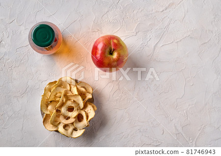 Apples chips on plate, apple fruit and bottle with juice Apples chips on plate, apple fruit and bottle with juice 81746943