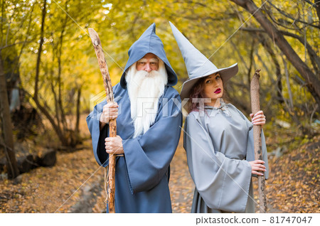 Wizard and sorceress in the autumn forest. Elderly man and woman in carnival costumes for halloween 81747047