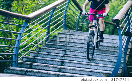 Woman freerider riding down stairs. Sports extreme and active lifestyle 81747724