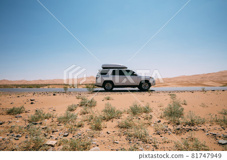 Inner Mongolia ,China - Circa 2021: Driving White 2020 Toyota 4Runner TRD crossing in the desert road trip Inner Mongolia ,China - Circa 2021: Driving White 2020 Toyota 4Runner TRD crossing in the desert road trip 81747949