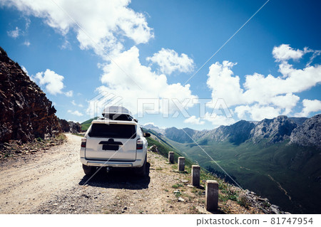 Driving off road car on high altitude mountain top Driving off road car on high altitude mountain top 81747954