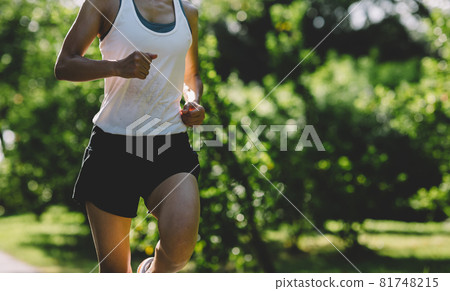 Fitness woman running on sunny tropical park trail Fitness woman running on sunny tropical park trail 81748215