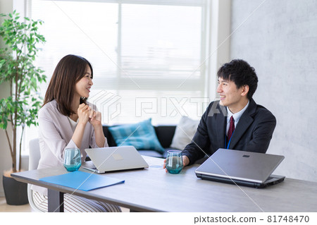 Men and women talking happily in the office Men and women talking happily in the office 81748470