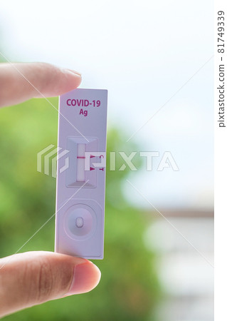 man holding Rapid Antigen Test kit with Negative result during swab COVID-19 testing. Coronavirus Self nasal or Home test, Lockdown and Home Isolation concept man holding Rapid Antigen Test kit with Negative result during swab COVID-19 testing. Coronavirus Self nasal or Home test, Lockdown and Home Isolation concept 81749339