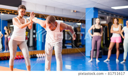 Asian woman practicing self-defence moves with her trainer 81751617