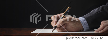 Image of a man's hand writing with a fountain pen on white paper 81751649