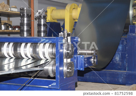 Process of cutting a wide sheet of metal into narrow strips on a machine, Russia Process of cutting a wide sheet of metal into narrow strips on a machine, Russia 81752598