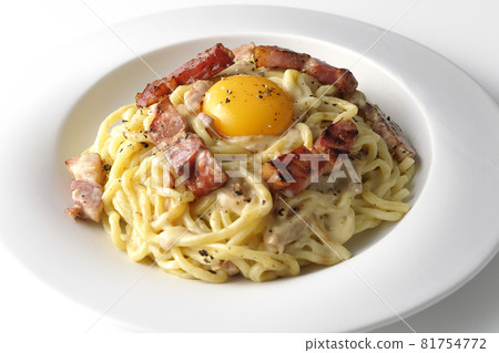 Carbonara with egg yolk and crispy thick-sliced bacon photographed on a white background 81754772