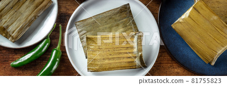 Tamal panorama. Traditional dish of Mexican cuisine, wrapped in green leaves Tamal panorama. Traditional dish of Mexican cuisine, wrapped in green leaves 81755823