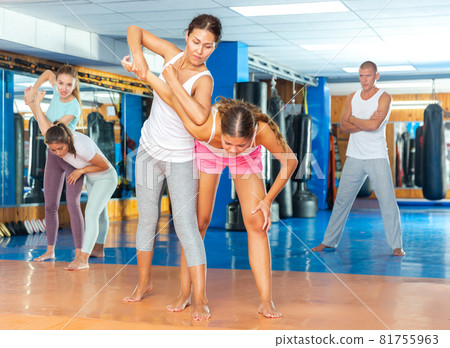 Sporty girls in pairs are training self-defence moves 81755963