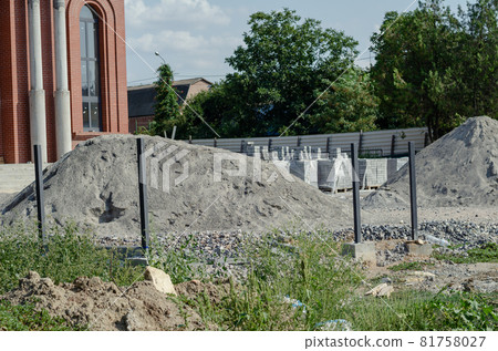 Construction site. Construction of a new building Modern Ukrainian Christian Orthodox Church. Redbrick building with arches and columns. Paving tiles, bricks, gravel and sand. Industry. Religion Construction site. Construction of a new building Modern Ukrainian Christian Orthodox Church. Redbrick building with arches and columns. Paving tiles, bricks, gravel and sand. Industry. Religion 81758027
