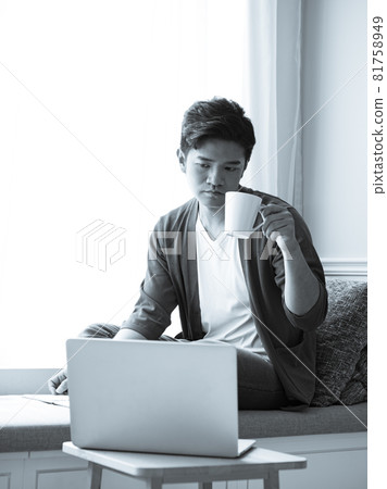 Asian young man sitting in front of laptop Asian young man sitting in front of laptop 81758949