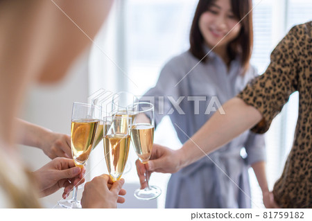Young men and women toasting at a party 81759182