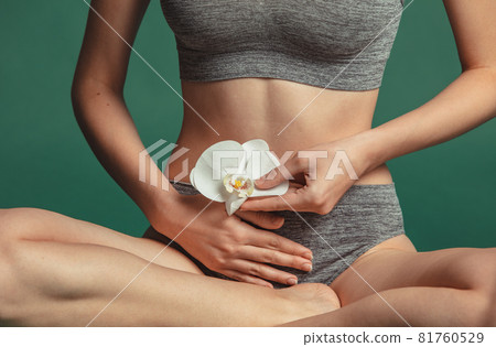 Cropped close-up portrait of young female sitting and touching belly isolated over green background. Pregnancy concept Cropped close-up portrait of young female sitting and touching belly isolated over green background. Pregnancy concept 81760529