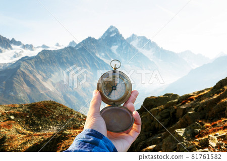 Monte Bianco mountains range and tourist hand with old metal compass 81761582