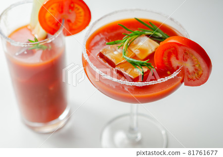 Bloody Mary cocktail prepared with pure vodka, tomato juice and hot pepper sauce, drink decorated with a slice of tomato Bloody Mary cocktail prepared with pure vodka, tomato juice and hot pepper sauce, drink decorated with a slice of tomato 81761677
