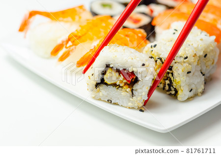 Set of smoked salmon nigiri, Ebi king prawn nigiri, katsu chicken and red pepper California roll, cucumber with wasabi hosomaki roll and red pepper hosomaki roll 81761711