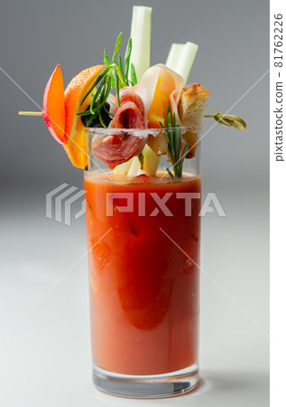 Bloody Mary with interesting decoration with a small snack on top of a cocktail glass Bloody Mary with interesting decoration with a small snack on top of a cocktail glass 81762226