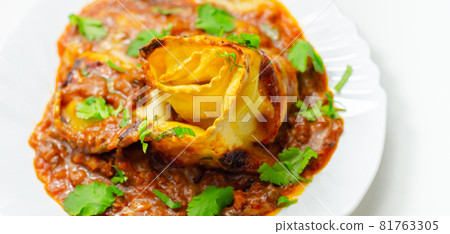 Hand rolled four cheese ravioli pasta in minced beef with Chianti red wine, garlic and herb ragu, and a bechamel sauce topped with pecorino cheese crumb and finished with fresh parsley 81763305
