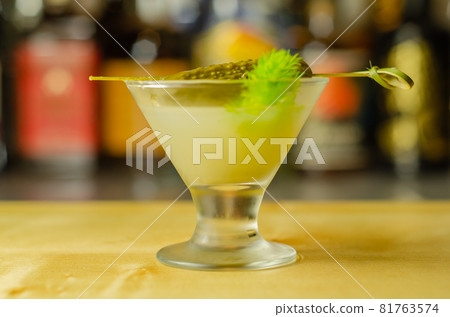 Shaken vodka and pickle juice with ice in shot glass and garnishing with small pickled cucumber and dill Shaken vodka and pickle juice with ice in shot glass and garnishing with small pickled cucumber and dill 81763574