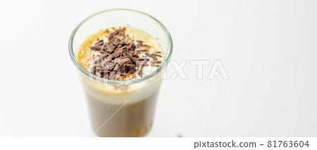 Coffee drink shot with a nutty note with fluffy milk foam, decorated with chocolate shavings Coffee drink shot with a nutty note with fluffy milk foam, decorated with chocolate shavings 81763604