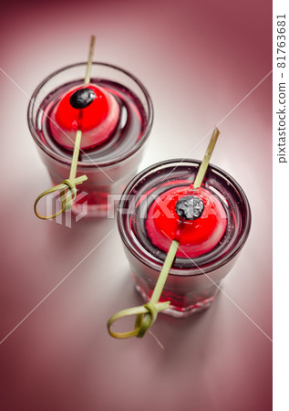 Scary drinks shots made with tequila, grenadine and tabasco decorated with jelly eyeball 81763681