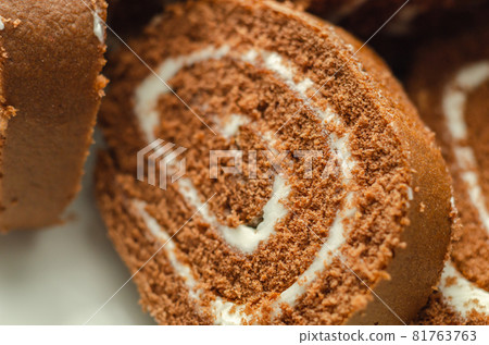 Chocolate sponge roll with a vanilla flavour filling, chocolate swiss roll Chocolate sponge roll with a vanilla flavour filling, chocolate swiss roll 81763763