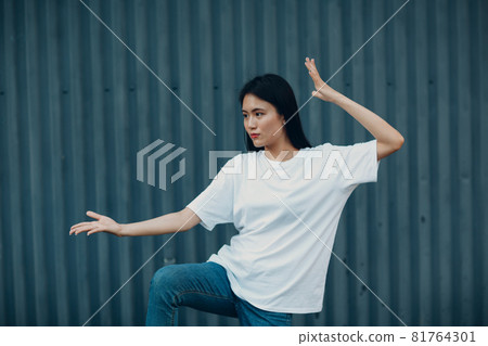 Asian young woman doing qigong exercise summer outdoor 81764301