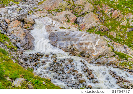 Wild alpine waterfall on Schlatenbach mountain stream. Gschloesstal Valley, Hohe Tauern National Park, East Tyrol, Austrian Alps 81764727