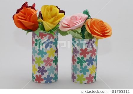 Handmade rose flowers made from origami are displayed in a beautiful vase Handmade rose flowers made from origami are displayed in a beautiful vase 81765311