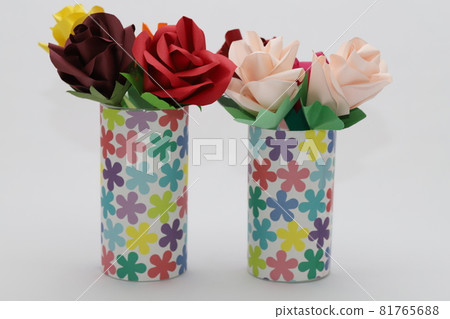 Handmade rose flowers made from origami are displayed in a beautiful vase 81765688