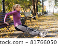 Young woman does push-up exercises in the park. Sports outside in autumn 81766050
