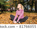 Young woman is doing sports outside in a autumn park 81766055
