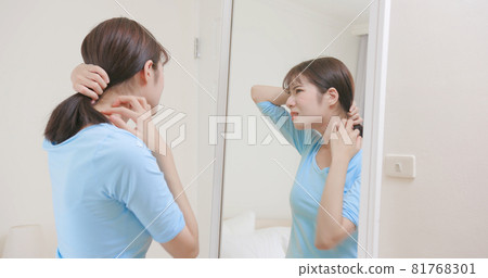 woman scratching her neck woman scratching her neck 81768301