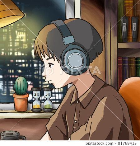 A man wearing headphones at a desk 81769412