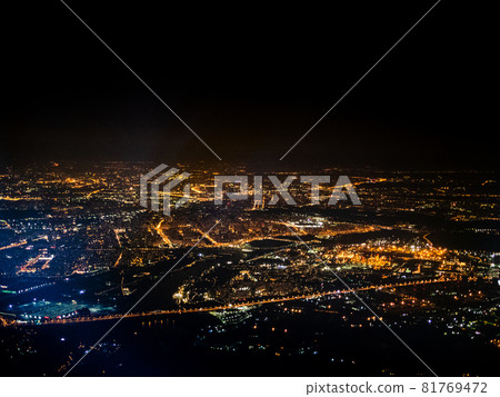 aerial view of illuminated suburbs of Moscow city at night from porthole while flying by plane aerial view of illuminated suburbs of Moscow city at night from porthole while flying by plane 81769472