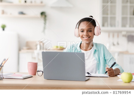 Smart african american schoolgirl in earphones study distant on computer at home, covid Smart african american schoolgirl in earphones study distant on computer at home, covid 81769954