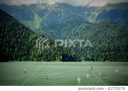 Catamarans on Lake Ritsa in Abkhazia. Walks on the water. Ecologically clean place in the mountains. Catamarans on Lake Ritsa in Abkhazia. Walks on the water. Ecologically clean place in the mountains. 81770270