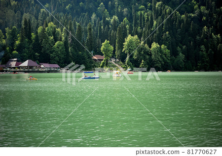 Catamarans on Lake Ritsa in Abkhazia. Walks on the water. Ecologically clean place in the mountains. 81770627