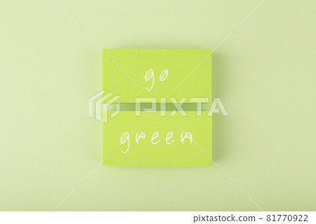 Modern composition with go green inscription against light pastel green background 81770922