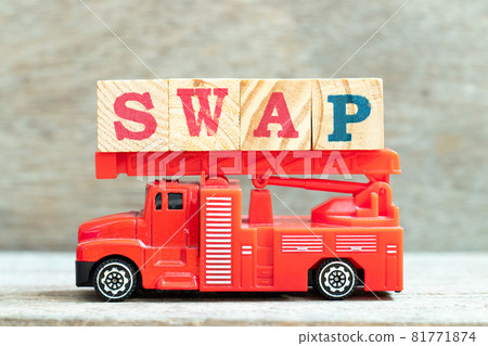 Fire ladder truck hold letter block in word swap on wood background 81771874