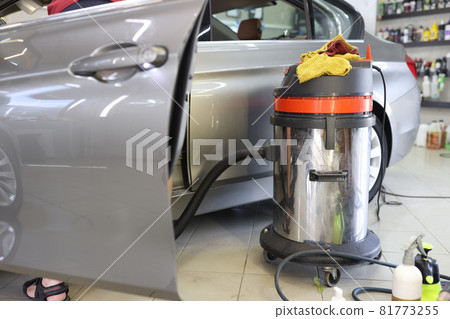 Cleaning car seat vacuum cleaners from dust closeup 81773255