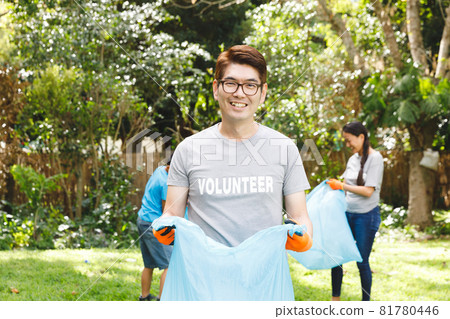 Portrait of smiling asian father, collecting rubbish in the countryside with son and daughter Portrait of smiling asian father, collecting rubbish in the countryside with son and daughter 81780446