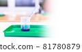 Microscopy and used laboratory glasses for the microscope are on a green tray after the study 81780879