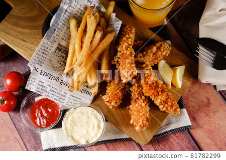 A hearty crispy chicken set with fries and juice A hearty crispy chicken set with fries and juice 81782299