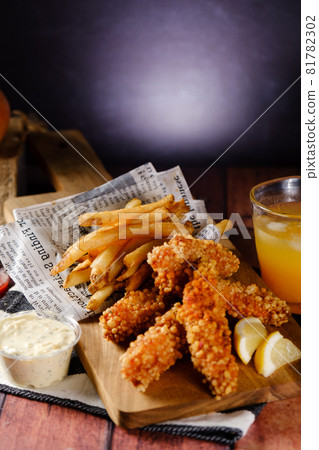A hearty crispy chicken set with fries and juice A hearty crispy chicken set with fries and juice 81782302